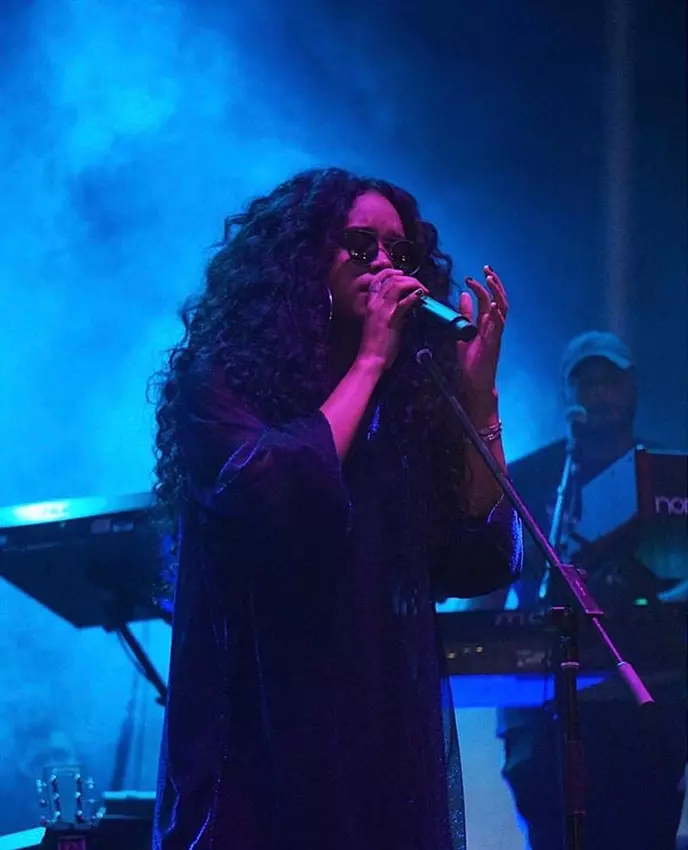 Experience the Enigmatic Presence of H.E.R.
