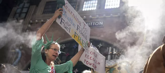 Marchers gather in worldwide protest of financial institutions "profiting off the climate crisis"